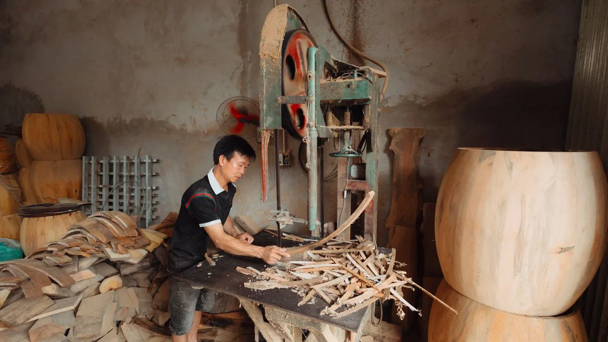 A craftsperson working in a bright wood workshop
