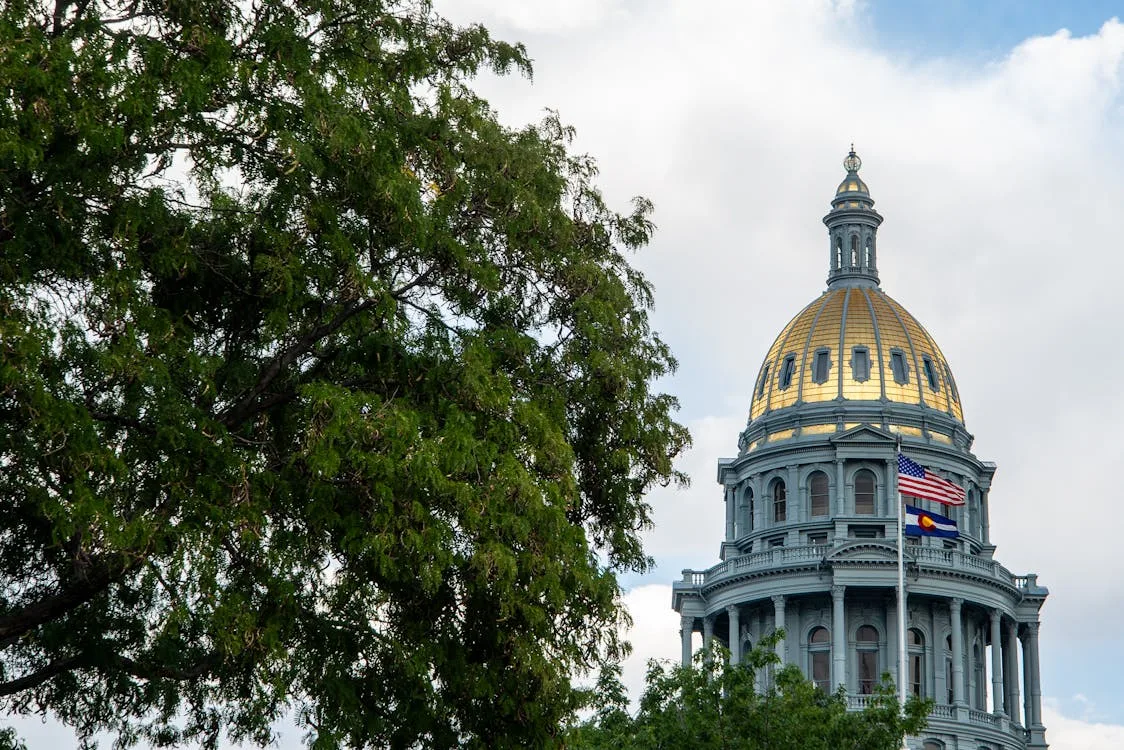 Colorado State Capitol building in Denver with flags in the foreground