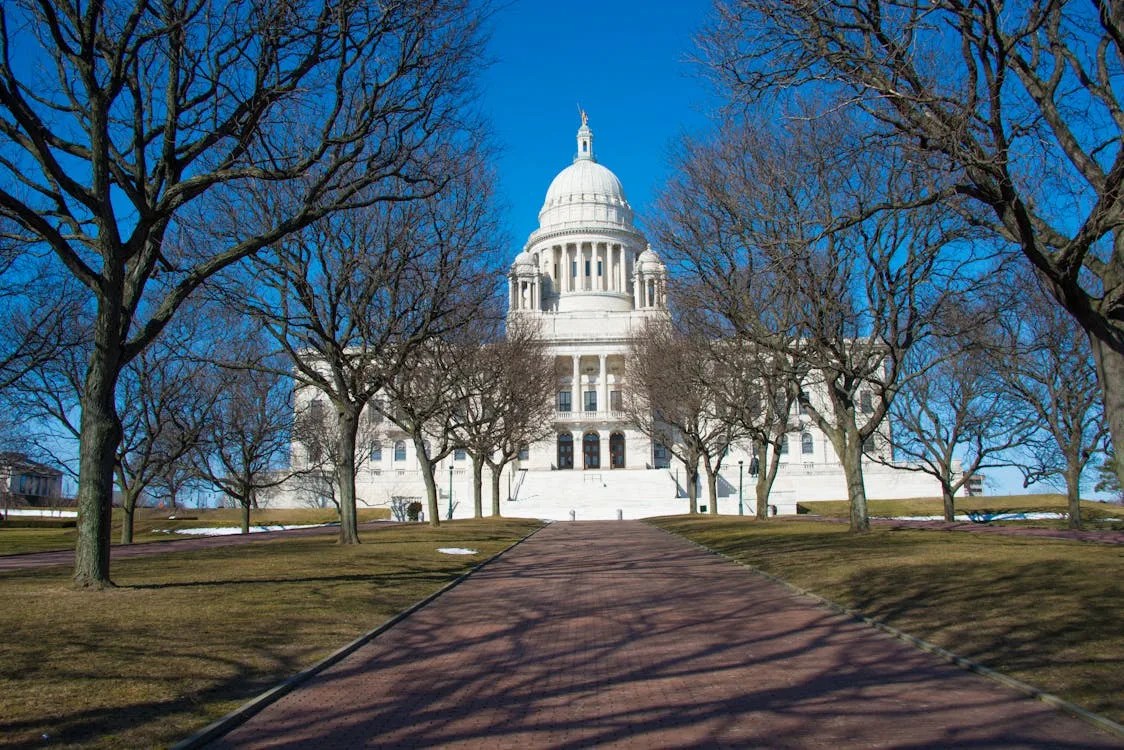 Rhode Island State House in Providence with leafless trees in the foreground